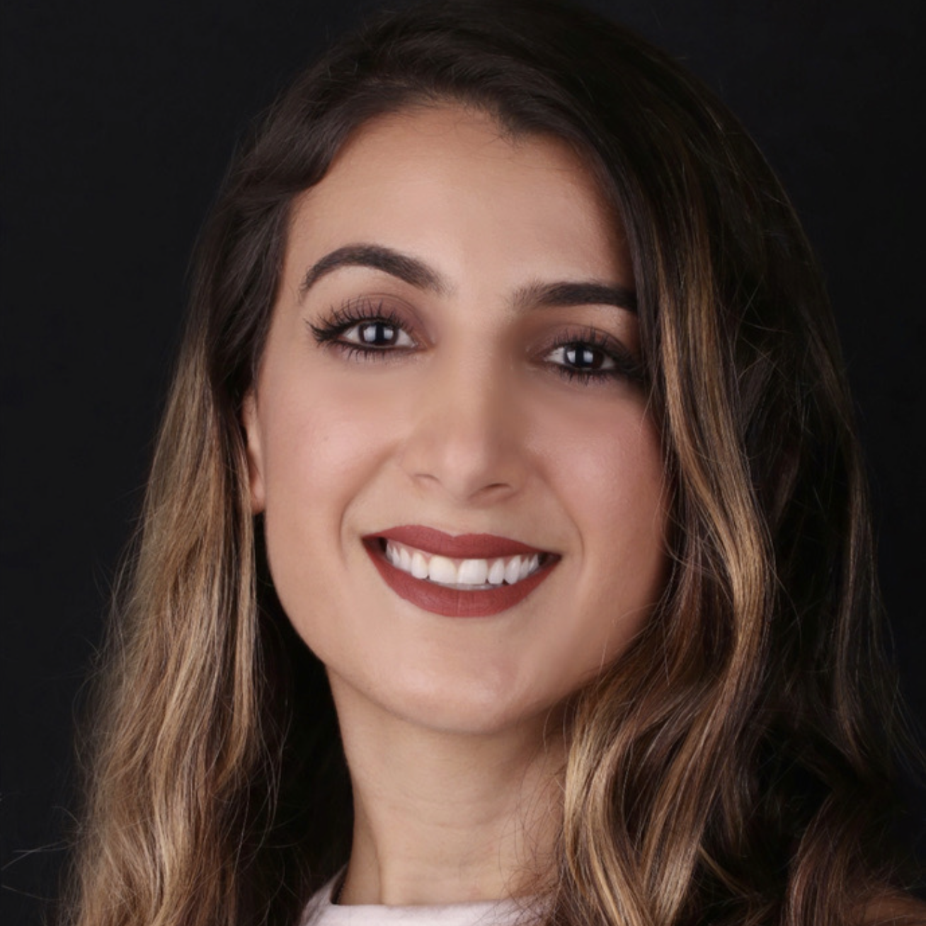 Professional headshot of Nadine Mirza